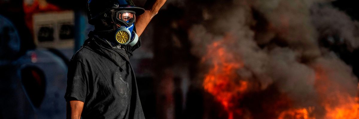 A demonstrator raises his fist in Chile