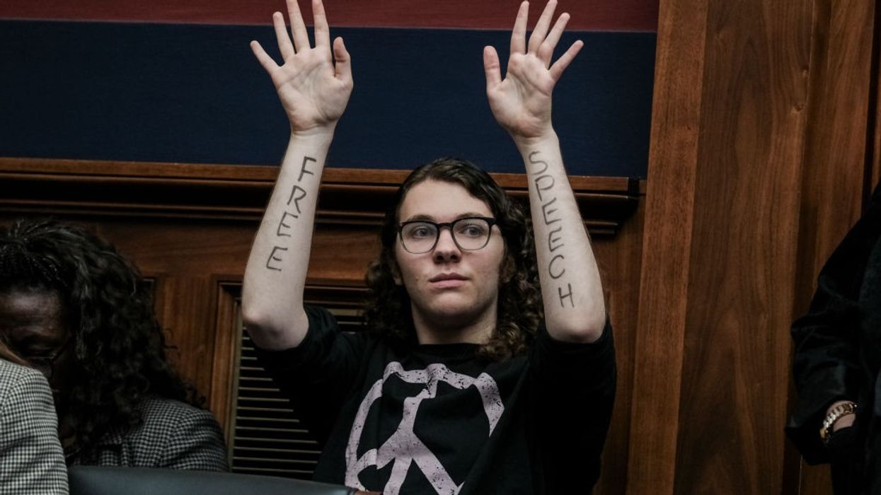 A demonstrator with Free Speech written on their forearms