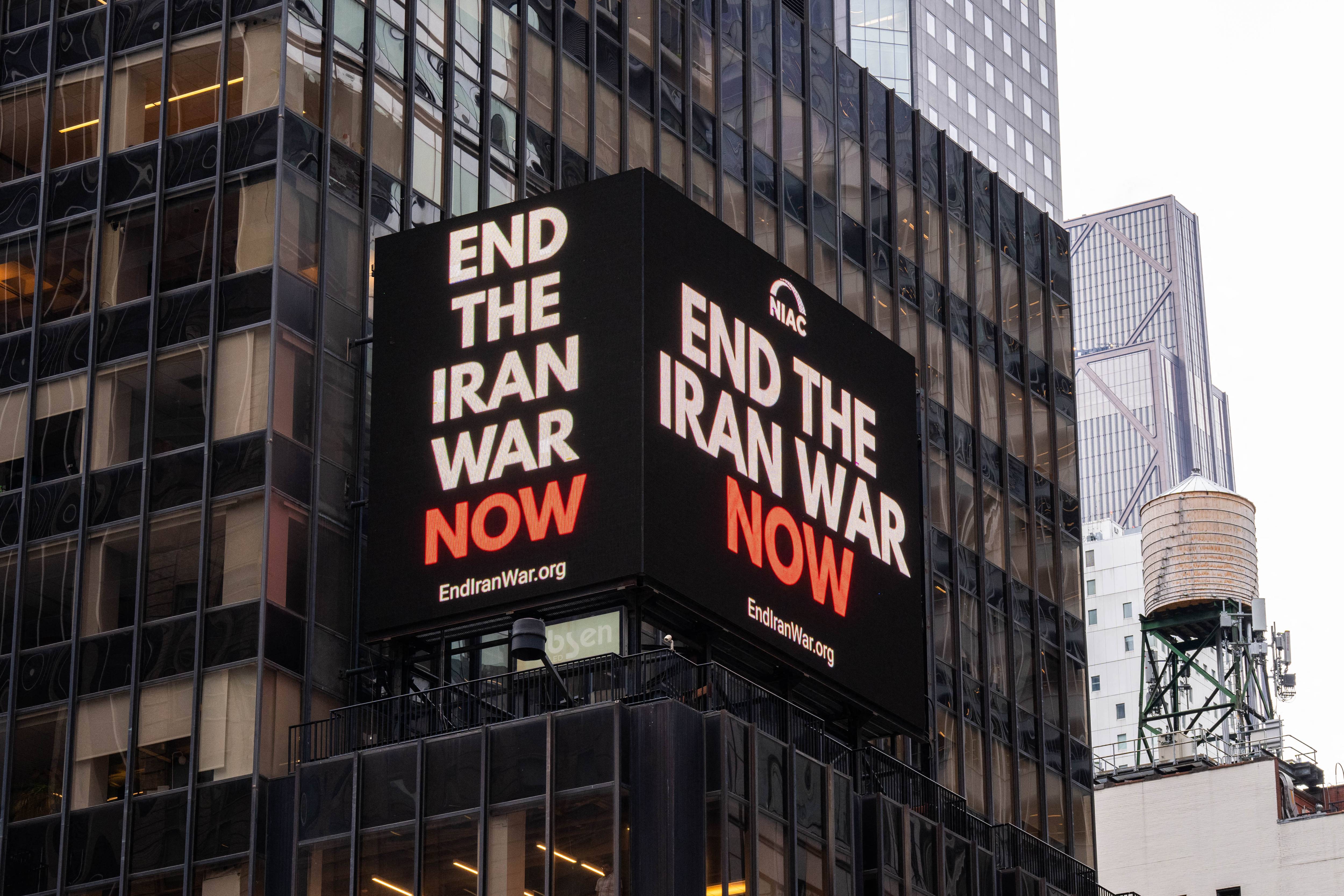 A digital billboard in Times Square says "End the Iran War Now"