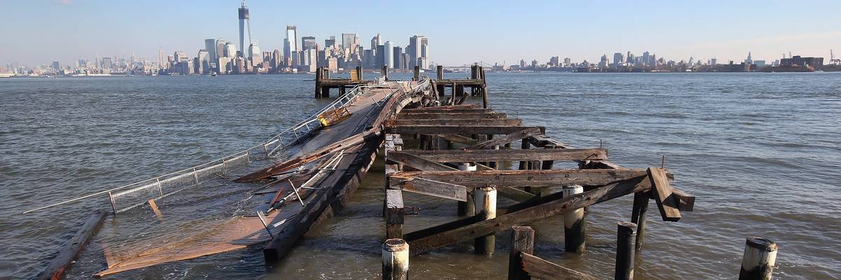 A dock damaged by Hurricane Sandy is seen with Manhattan in the background.