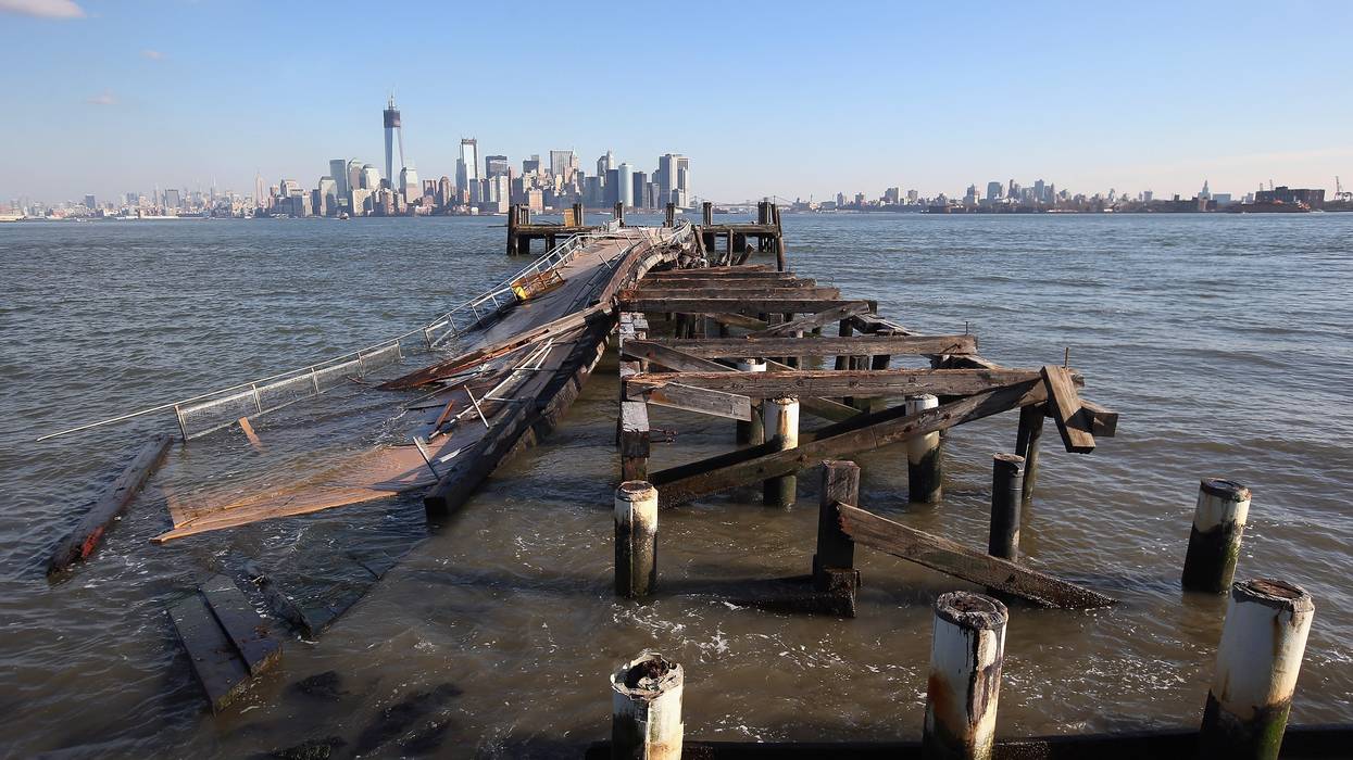 A dock damaged by Hurricane Sandy is seen with Manhattan in the background.