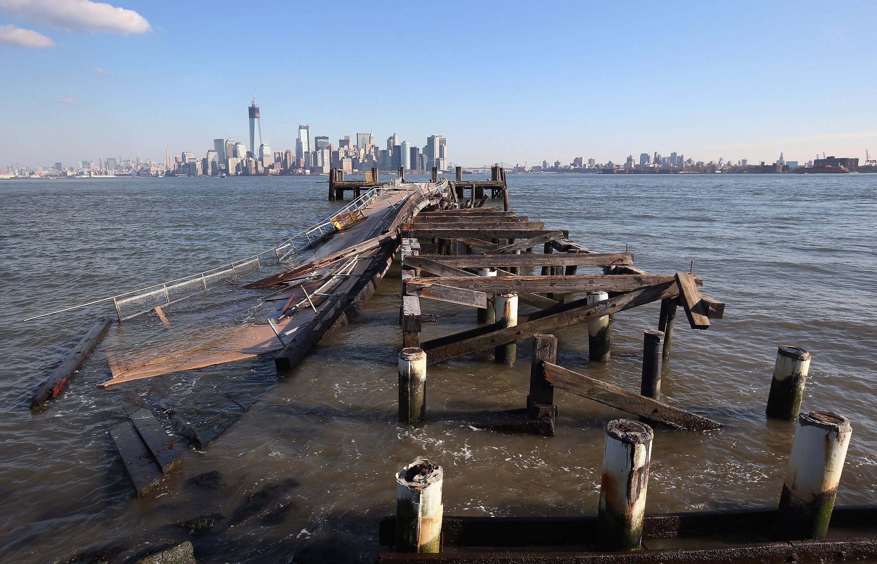 A dock damaged by Hurricane Sandy is seen with Manhattan in the background.