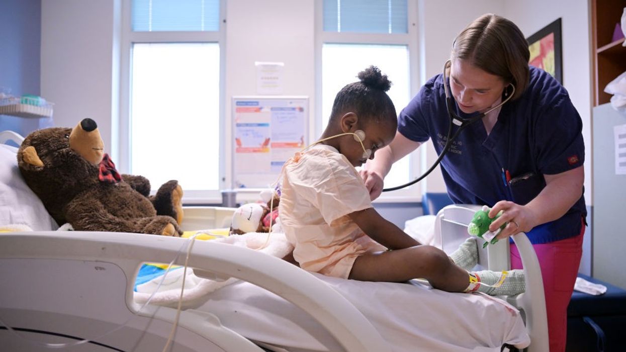 A doctor examines a 6-year-old patient