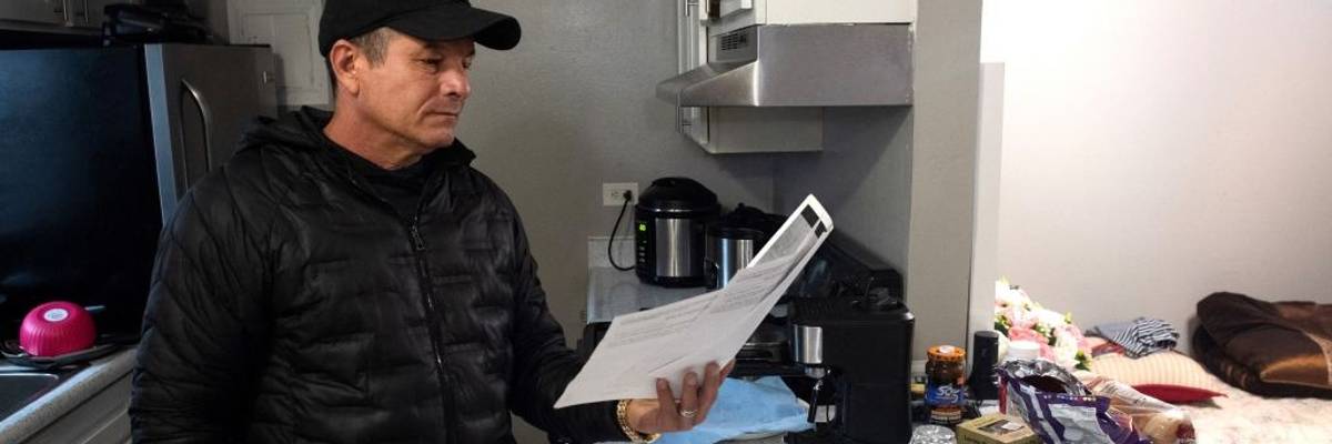 A documented Cuban immigrant holds his son's legal paperwork