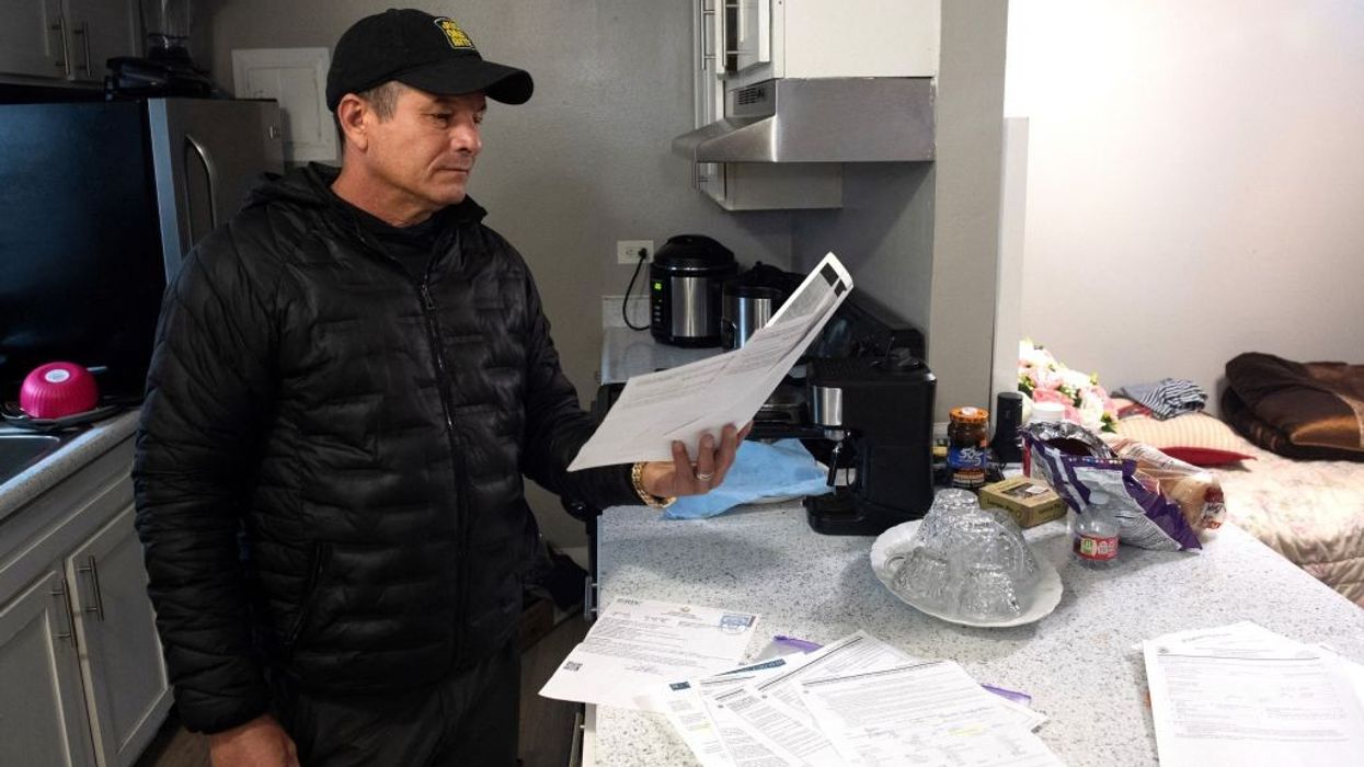 A documented Cuban immigrant holds his son's legal paperwork