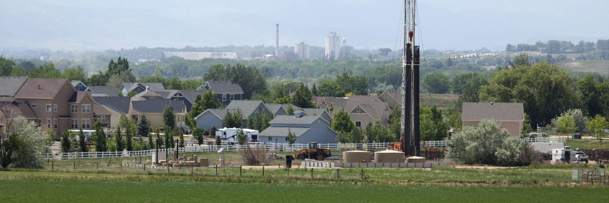 A drill rig operates near homes in Frederick, Colorado.