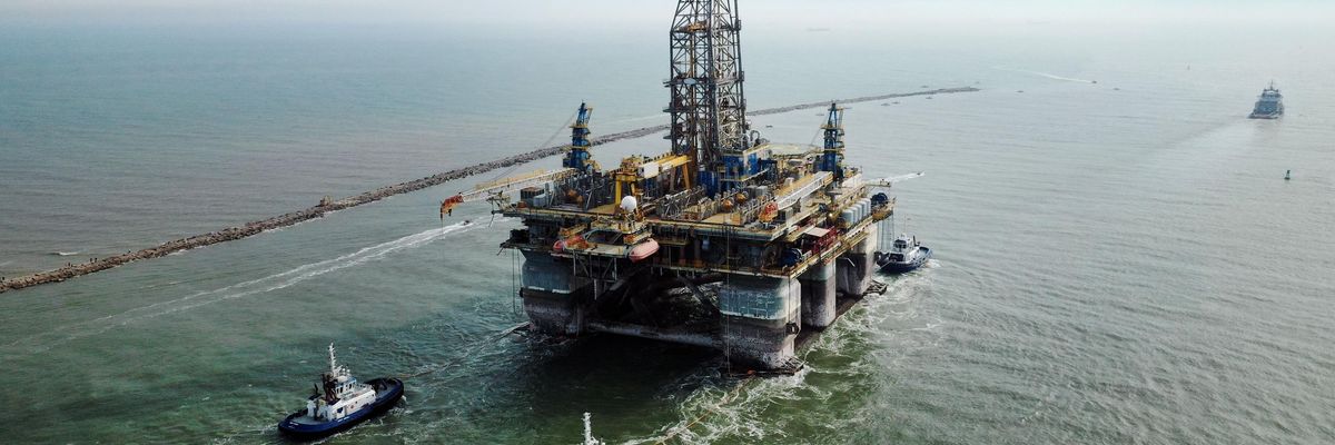 A drilling platform is pulled into the Gulf of Mexico