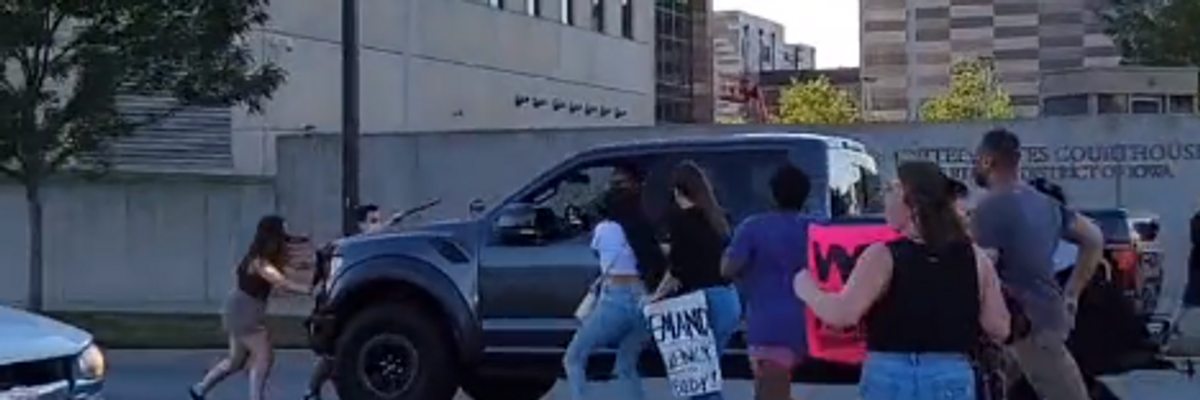 A driver is seen running into abortion rights defenders in Cedar Rapids, Iowa on June 24, 2022.