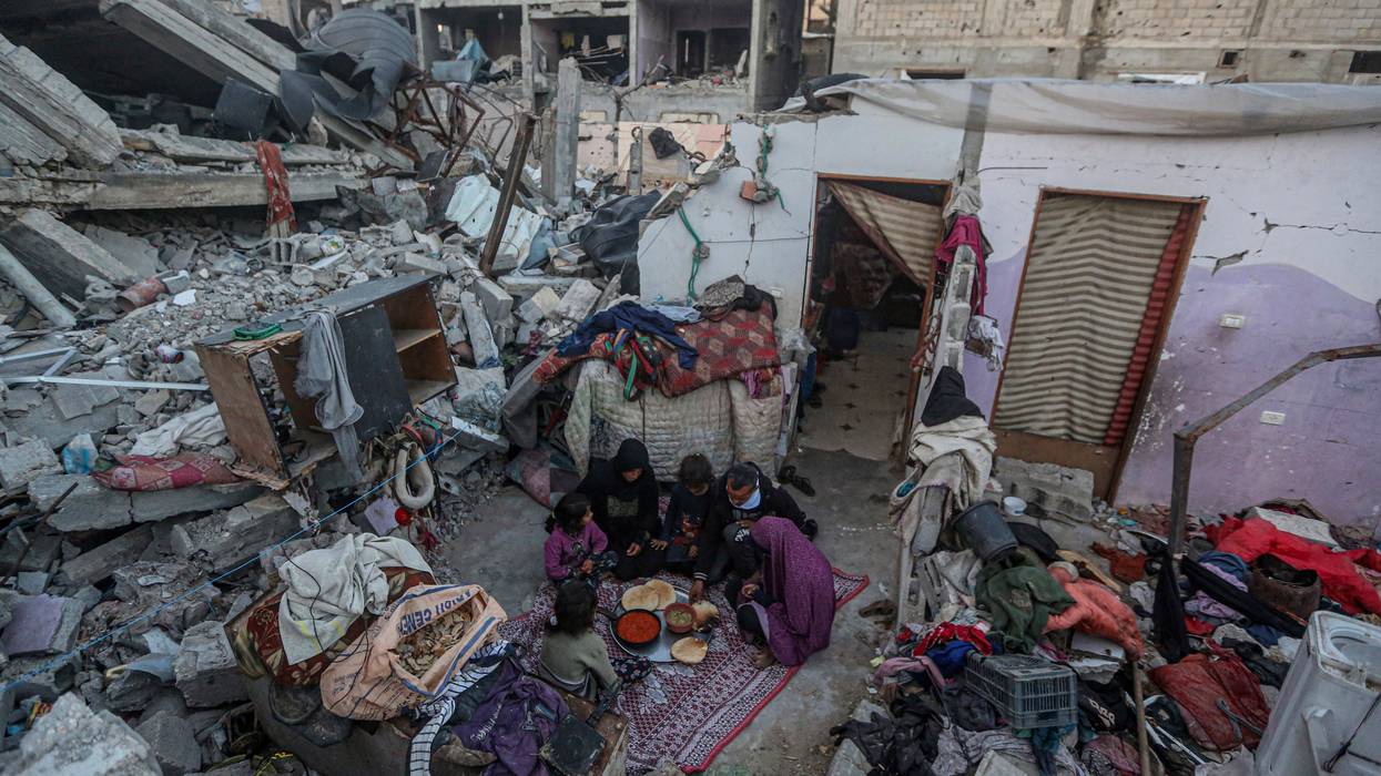 A family breaks the Ramadan fast amid rubble in Gaza.