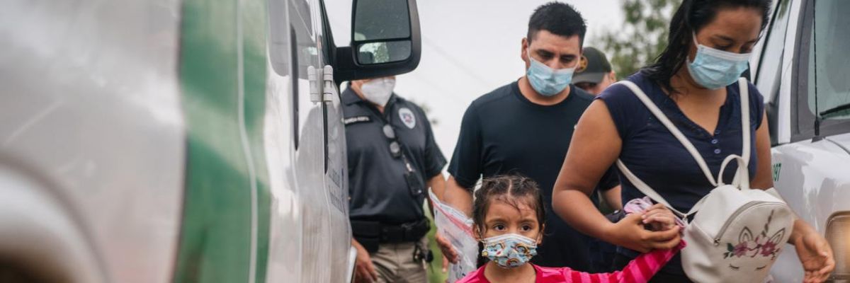 A family is taken to an immigration processing center after crossing the U.S.-Mexico border.