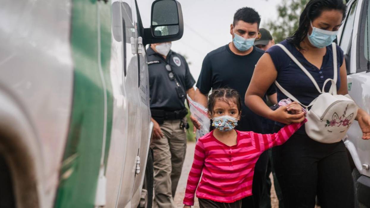 A family is taken to an immigration processing center after crossing the U.S.-Mexico border.