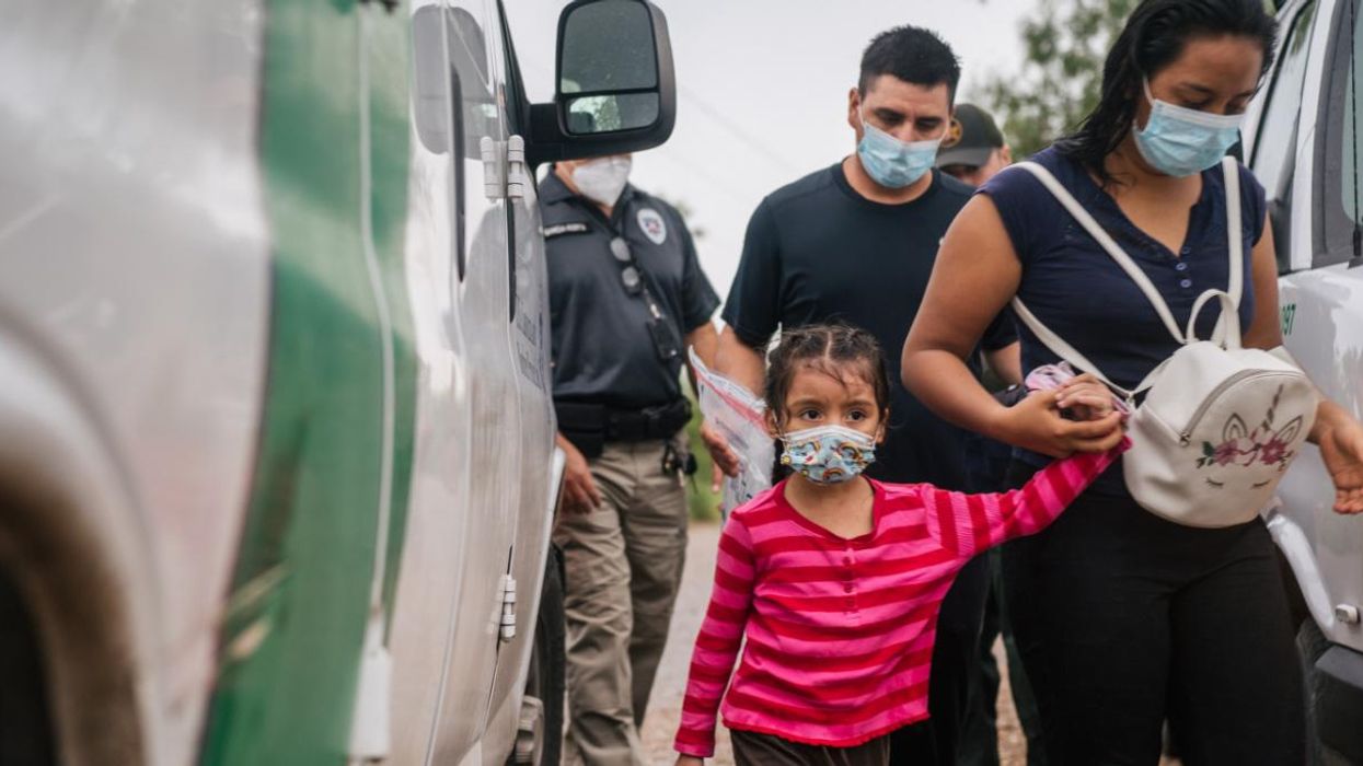 A family is taken to an immigration processing center after crossing the U.S.-Mexico border.