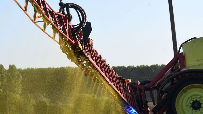 A farmer sprays Roundup on a field of no-till corn in Piace, France
