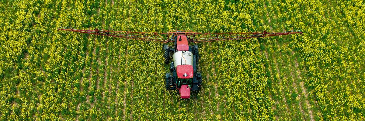A farmer spreads pesticides