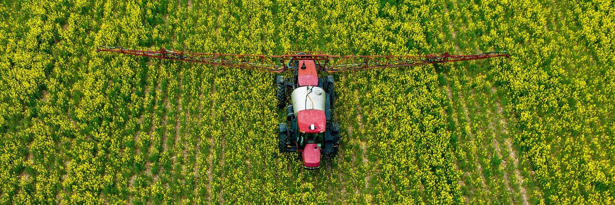 A farmer spreads pesticides