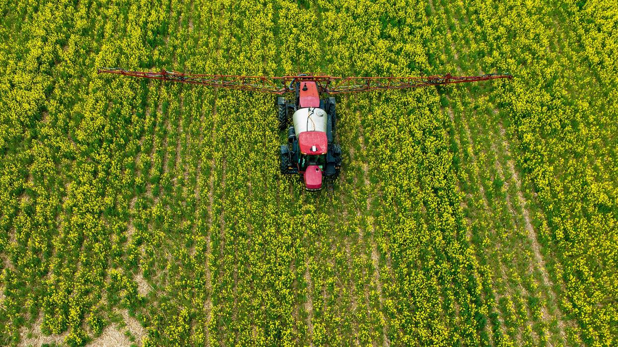 A farmer spreads pesticides