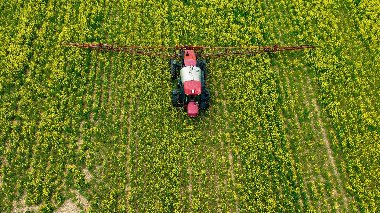 A farmer spreads pesticides