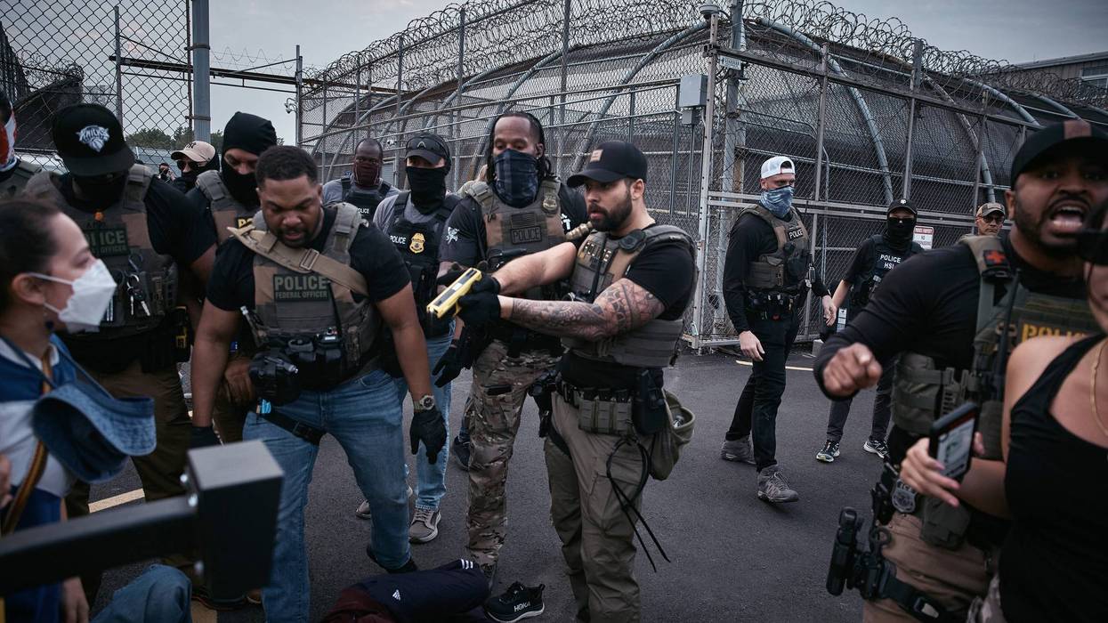 A federal agent threatens to Taser protesters during a protest in Newark, NJ.