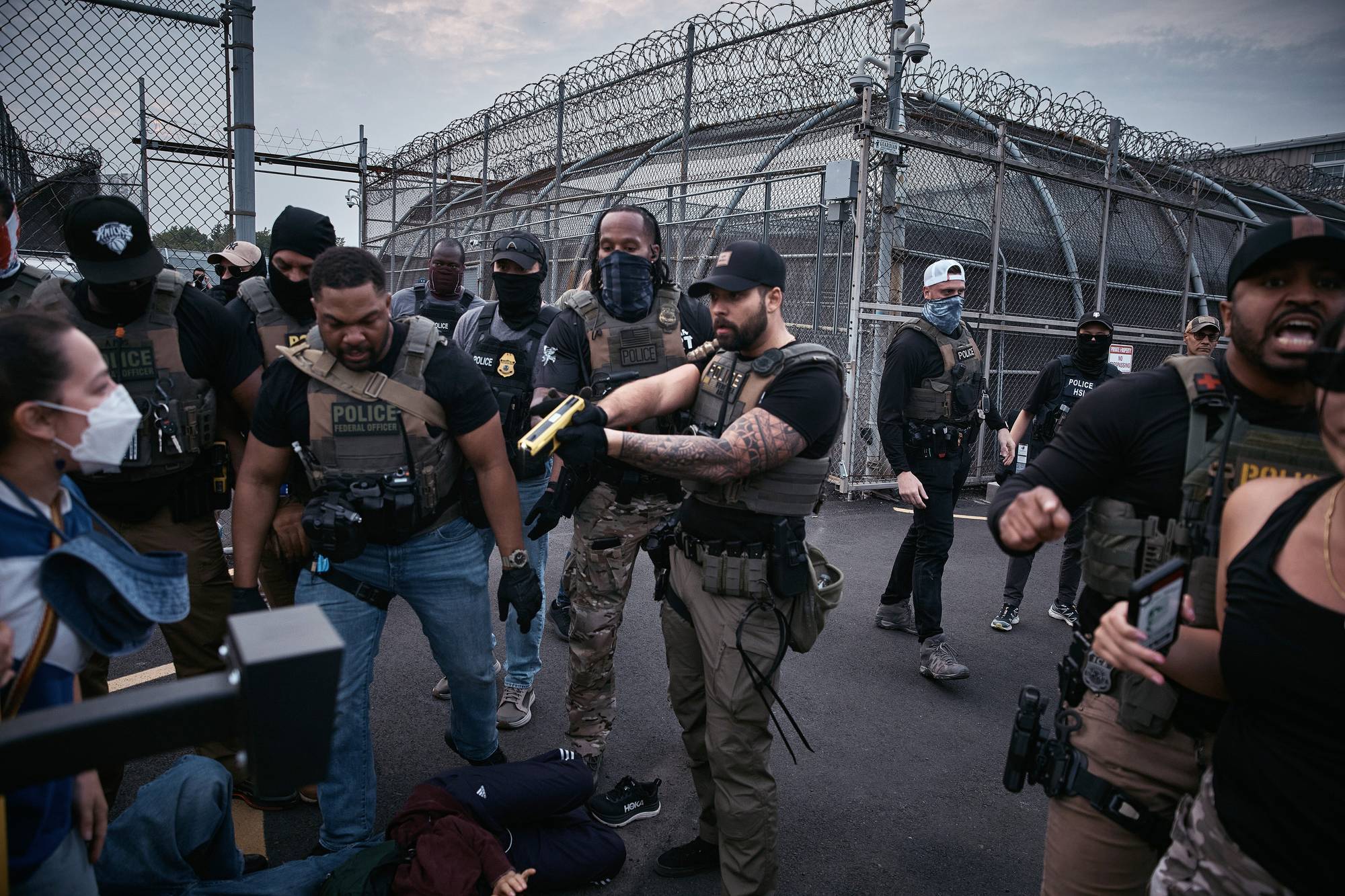 A federal agent threatens to Taser protesters during a protest in Newark, NJ.