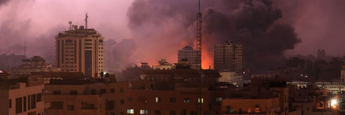 A fireball erupts over a building in Gaza.