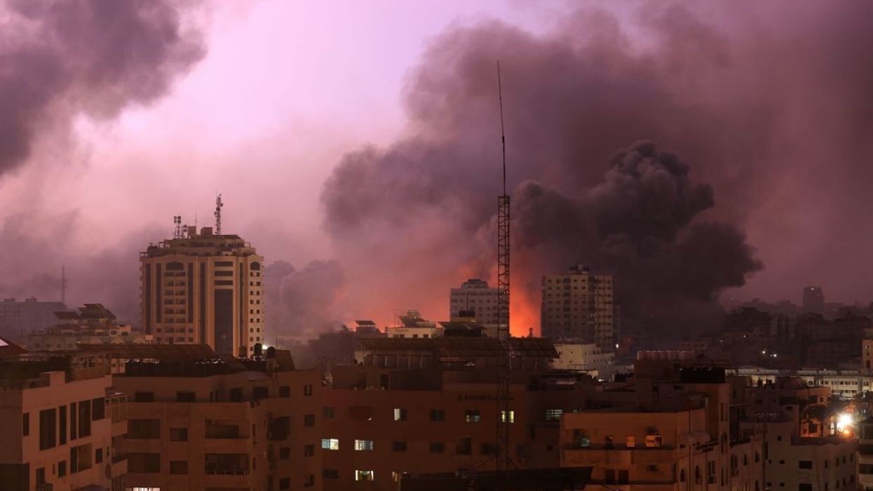 A fireball erupts over a building in Gaza.