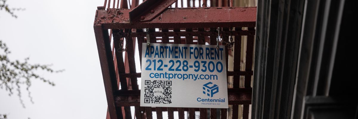 A for-rent sign hangs from a fire escape.