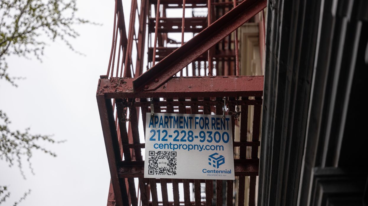 A for-rent sign hangs from a fire escape.