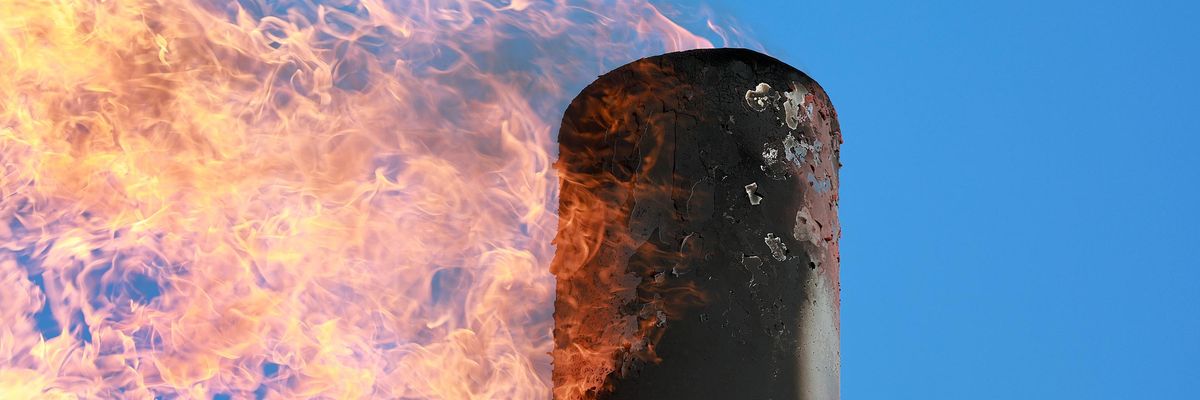 A gas flare is seen at a production site