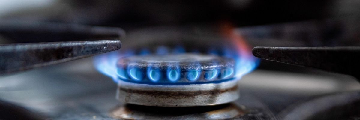 A gas stove lets off a blue flame