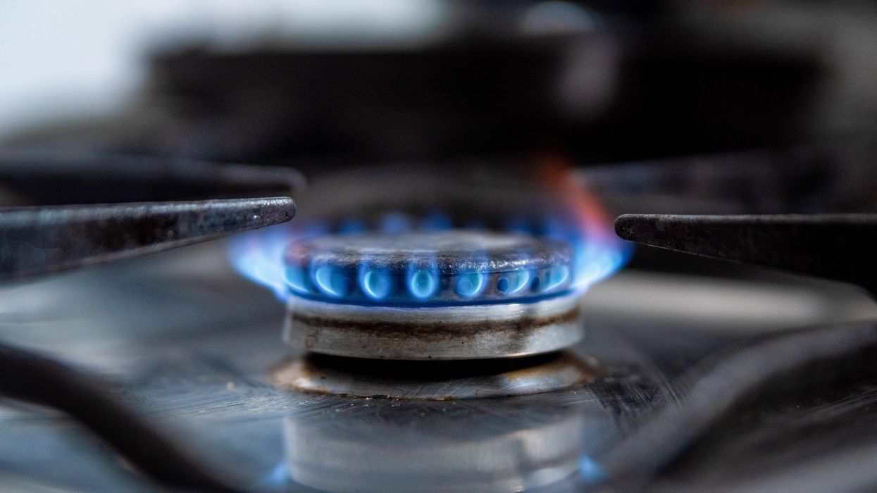 A gas stove lets off a blue flame