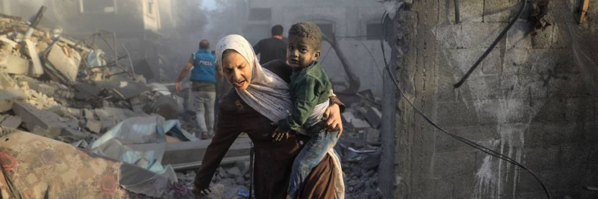 A Gazan mother and child flee an Israeli airstrike at al-Maghazi refugee camp