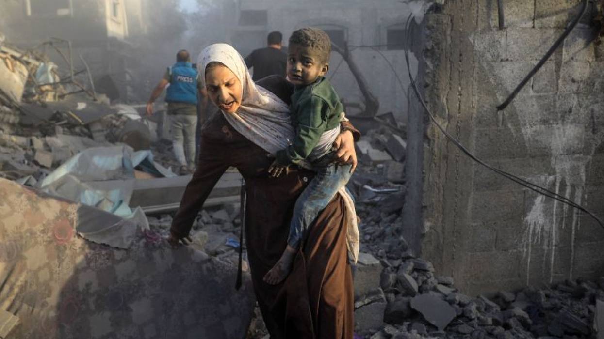 A Gazan mother and child flee an Israeli airstrike at al-Maghazi refugee camp
