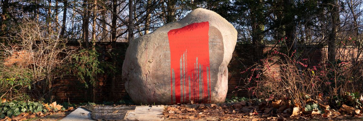 A German colonial memorial drenched in red paint.