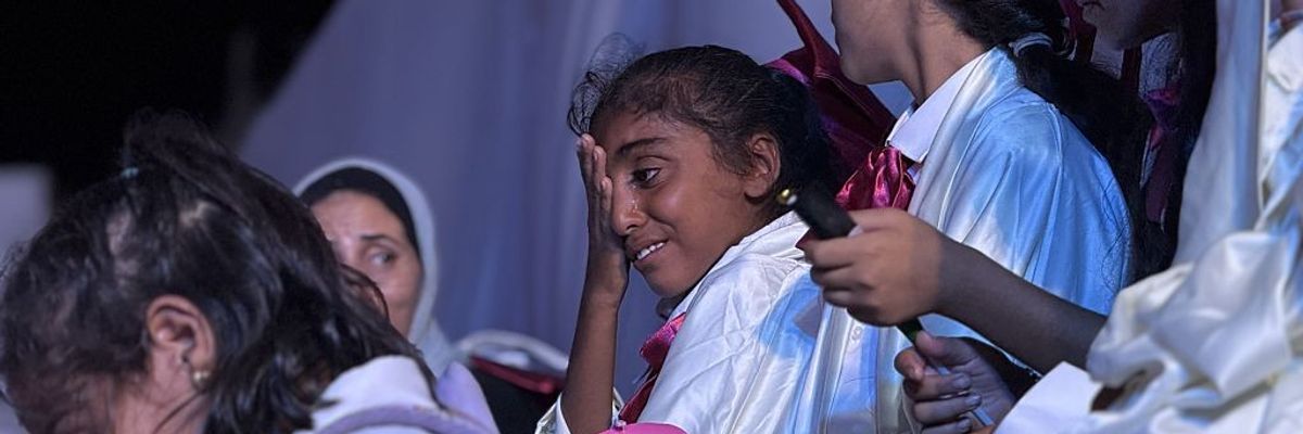 A girl cries during a graduation ceremony at a school for Gaza orphans