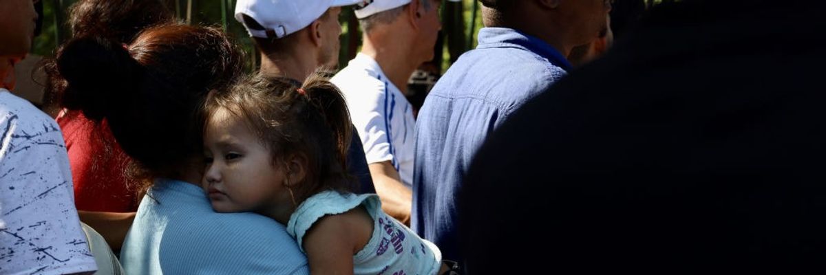 A girl waits with her mother to be processed by the Mexican Refugee Commission