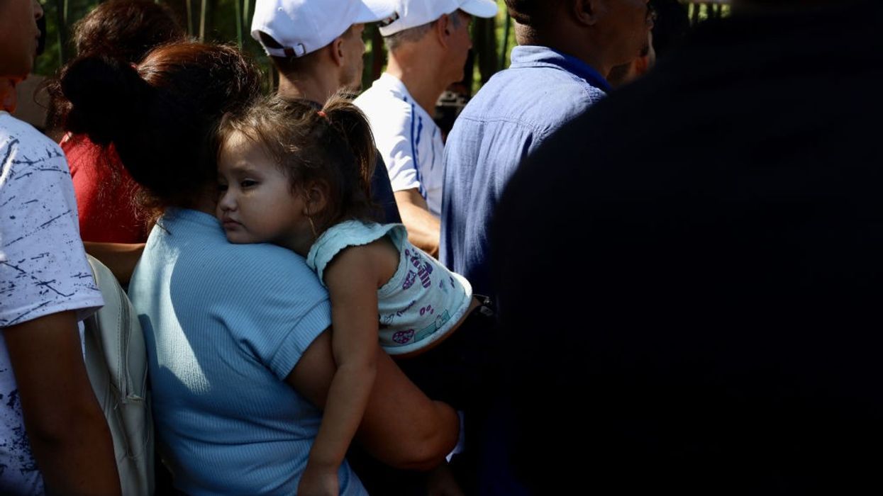 A girl waits with her mother to be processed by the Mexican Refugee Commission