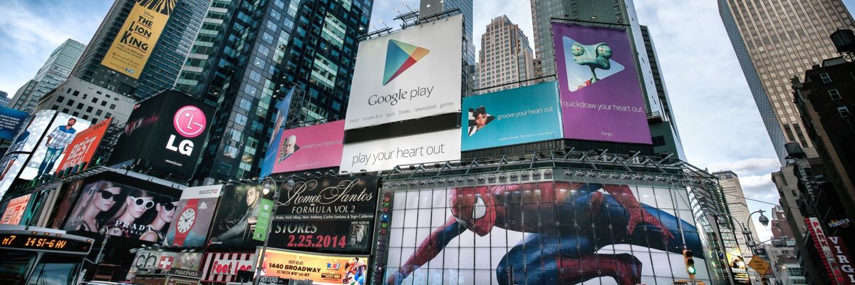 A Google Play ad is centered in a picture of Time Square billboards. 