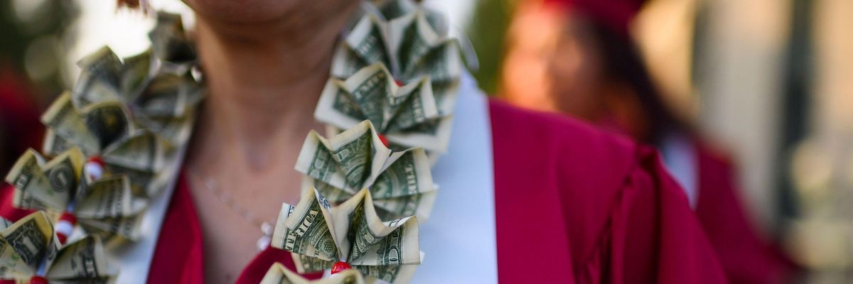 A graduating student wears a money lei, a necklace made of U.S. dollar bills