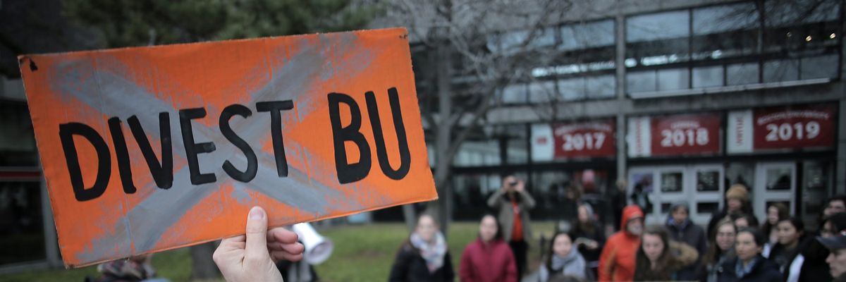A group of Boston University students walk out of classes on January 23, 2017 to launch a campaign urging BU president Robert Brown to divest the university's endowment from fossil fuel companies.