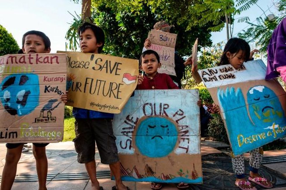 A group of Indonesians hold placards as they take part in a global climate change campaign in Surabaya on September 20, 2019. (Photo: Juni Kriswanto/AFP/Getty Images)