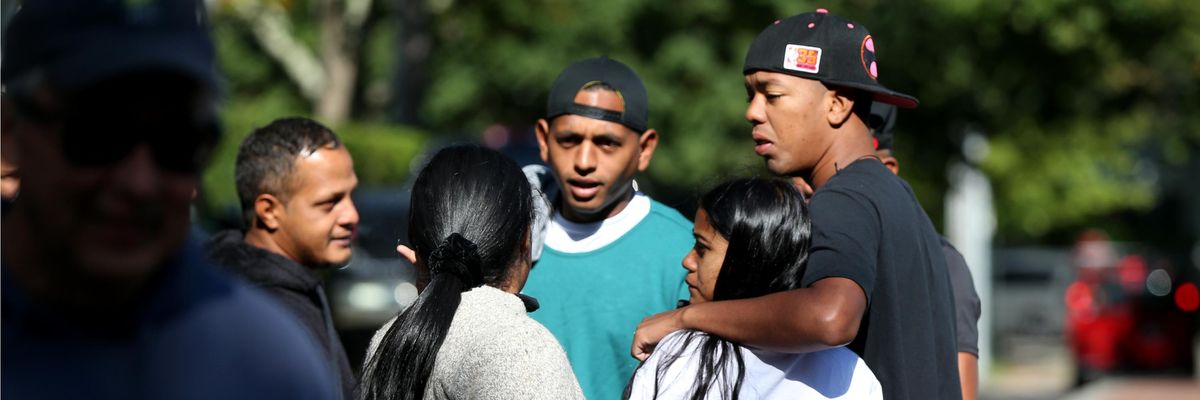 A group of migrants stands close together on Martha's Vineyard.