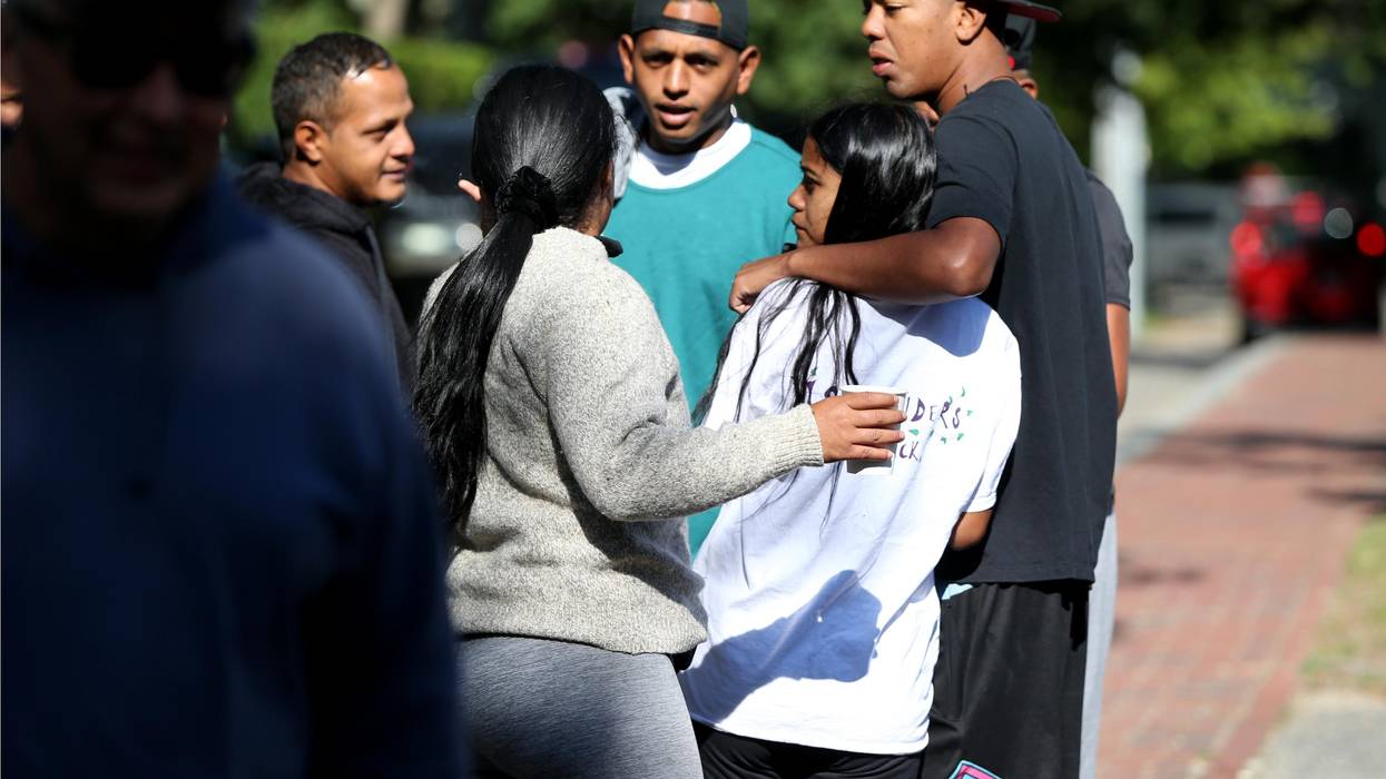 A group of migrants stands close together on Martha's Vineyard.