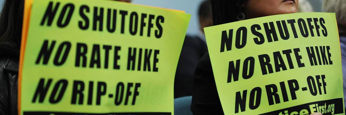 A group of protesters display anti-Pepco signs.