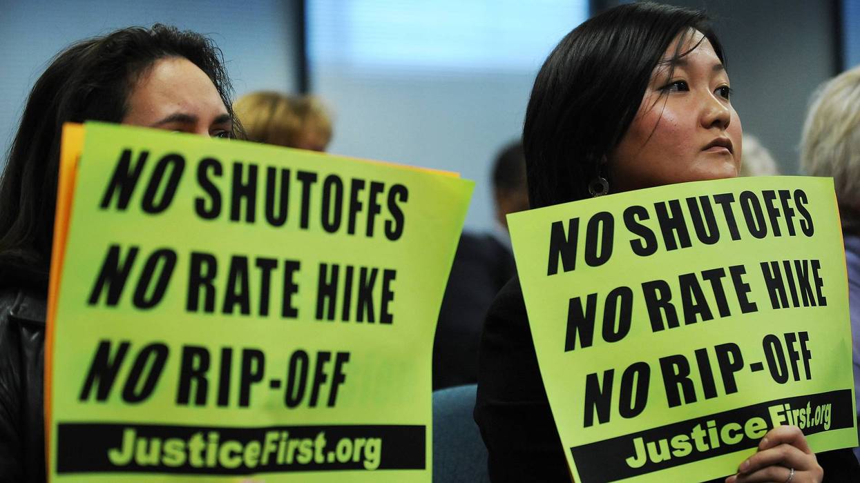 A group of protesters display anti-Pepco signs.