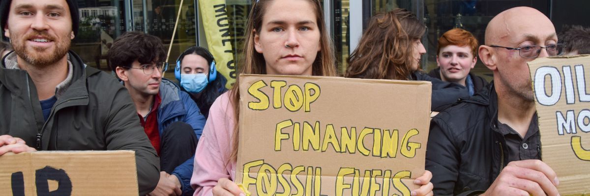 a group of protestors hold signs