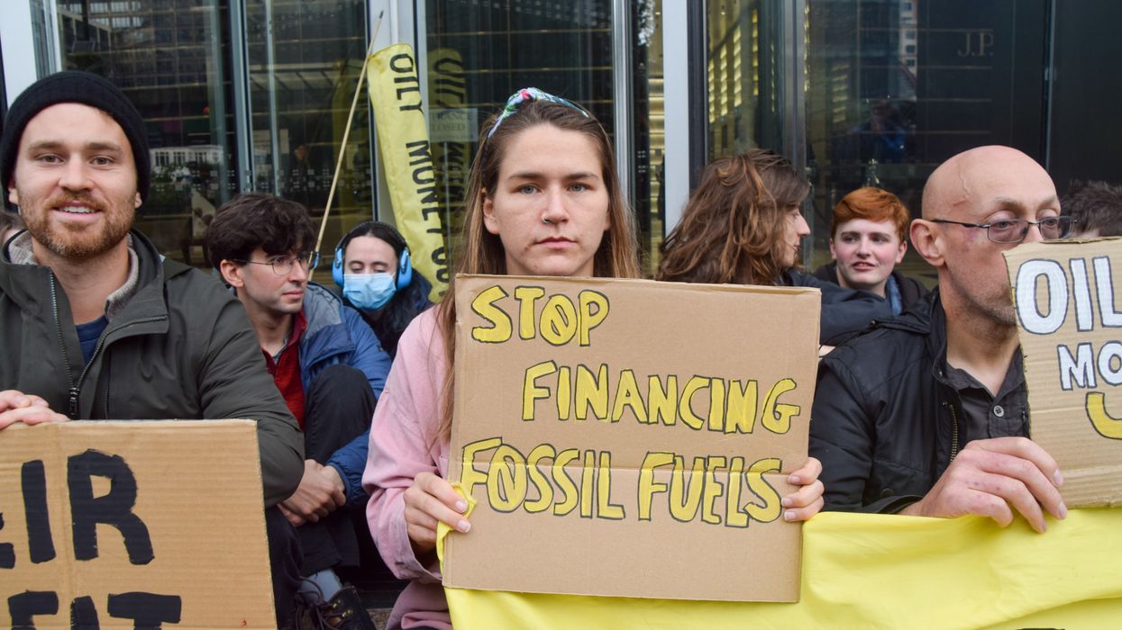 a group of protestors hold signs