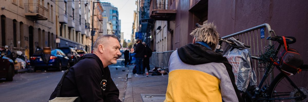 A harm reduction worker speaks to a person on the streets of San Francisco
