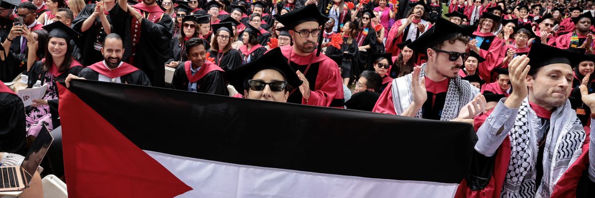 A Harvard graduate displays a Palestinian flag.