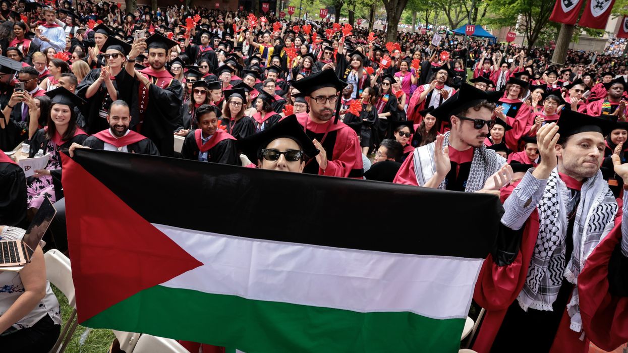 A Harvard graduate displays a Palestinian flag.