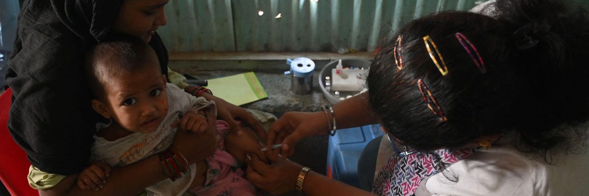 A health worker administers a vaccine to a child following a measles outbreak that killed at least 10 children in Mumbai on November 23, 2022.